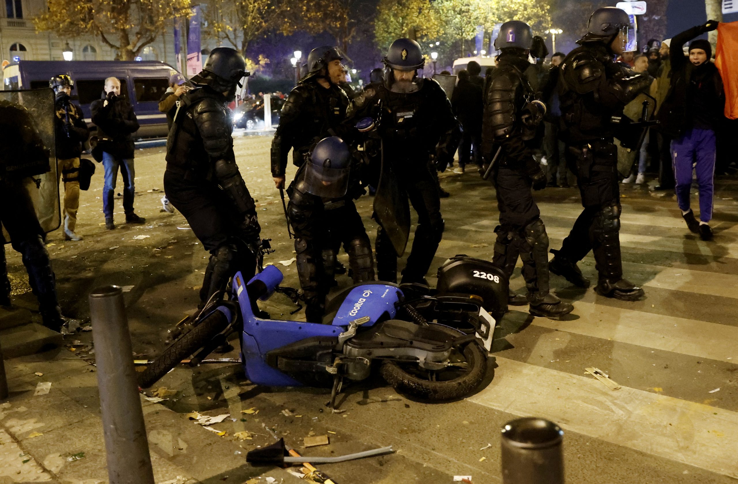 Soccer Football - FIFA World Cup Qatar 2022 - Fans gather in Paris for Morocco v Portugal - Paris, France - December 10, 2022 Police officers are seen near a motorbike during the Morocco fans celebrations REUTERS/Benoit Tessier